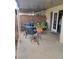 Cozy covered patio area with comfortable seating, potted plants, and a view of the backyard at 1652 W Campbell Ave, Phoenix, AZ 85015