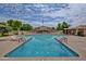 Community pool featuring blue railings, clear water, and a nearby building with an American flag at 1652 W Campbell Ave, Phoenix, AZ 85015
