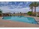 A refreshing community pool surrounded by palm trees and well-maintained lounging areas, perfect for relaxation at 1652 W Campbell Ave, Phoenix, AZ 85015