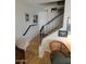 Stairway with wood steps, black metal railing, and art displayed throughout at 1652 W Campbell Ave, Phoenix, AZ 85015