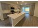 Stylish kitchen features gray cabinets, white countertops, stainless steel appliances, and large island at 17422 W Las Palmaritas Dr, Waddell, AZ 85355