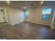 Inviting living room with wood-look floors, recessed lighting, and abundant natural light from multiple windows at 17422 W Las Palmaritas Dr, Waddell, AZ 85355
