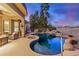 A backyard with a covered patio, pool, and golf course views, perfect for relaxation at 19423 N Canyon Whisper Dr, Surprise, AZ 85387