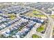 The aerial shot shows the home's location within a neighborhood with mature landscaping and a green space with walking trails at 20408 E Rosa Rd, Queen Creek, AZ 85142