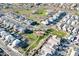 A high angle showcases community green spaces featuring walking paths and covered seating areas amid neatly planned residential blocks at 20408 E Rosa Rd, Queen Creek, AZ 85142