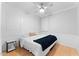 Calm bedroom featuring hardwood floors, paneled walls, and a large bed at 20408 E Rosa Rd, Queen Creek, AZ 85142
