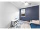 Bright bedroom with a ceiling fan, a window, and a small bookshelf at 20408 E Rosa Rd, Queen Creek, AZ 85142