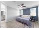 Comfortable bedroom with a ceiling fan, a blue accent wall, and natural light at 20408 E Rosa Rd, Queen Creek, AZ 85142