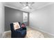 Relaxing bedroom featuring an accent wall and a comfortable glider chair at 20408 E Rosa Rd, Queen Creek, AZ 85142