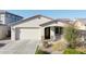 Charming single-story home featuring a well-maintained lawn, desert landscaping, and an attached two-car garage at 20408 E Rosa Rd, Queen Creek, AZ 85142
