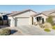 Well-maintained single-story home with a two-car garage, desert landscaping, and a tidy front yard at 20408 E Rosa Rd, Queen Creek, AZ 85142