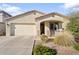 Charming single-story home featuring a stucco facade, well-kept landscaping, and a two-car garage at 20408 E Rosa Rd, Queen Creek, AZ 85142