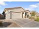 Inviting home with a two-car garage, covered porch, and desert landscaping for low maintenance appeal at 20408 E Rosa Rd, Queen Creek, AZ 85142