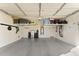 Spacious two-car garage with epoxy flooring, shelving, storage racks, and ample space for vehicles and storage solutions at 20408 E Rosa Rd, Queen Creek, AZ 85142
