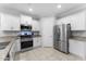 Well-equipped kitchen with stainless steel appliances, granite counters, and ample cabinet space for storage at 20408 E Rosa Rd, Queen Creek, AZ 85142