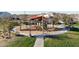 The community playground features modern play structures and equipment for climbing and sliding, covered by shade canopies at 20408 E Rosa Rd, Queen Creek, AZ 85142