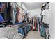 Spacious walk-in closet with ample storage shelves, rods, and organized clothing at 20408 E Rosa Rd, Queen Creek, AZ 85142