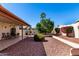Spacious backyard with covered patio, outdoor dining area, desert landscaping, and mature trees at 2120 E Daley Ln, Phoenix, AZ 85024