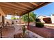 Covered patio with a table and chairs overlooking a well landscaped backyard with rock at 2120 E Daley Ln, Phoenix, AZ 85024