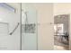 Modern bathroom with a glass-enclosed shower, white tiling, and a niche at 2120 E Daley Ln, Phoenix, AZ 85024