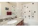 Clean bathroom featuring granite countertops, updated fixtures, and white tiled walls at 2120 E Daley Ln, Phoenix, AZ 85024