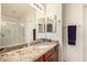 Bathroom featuring granite countertops, double mirrors, and a full size shower at 2120 E Daley Ln, Phoenix, AZ 85024