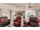 Open-concept living room with comfortable seating and a view into the kitchen and dining area at 2120 E Daley Ln, Phoenix, AZ 85024