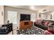 Comfortable living room showcasing a large television and a cozy black leather sofa at 2120 E Daley Ln, Phoenix, AZ 85024