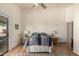 Sunlit main bedroom with a sliding glass door to the patio and hardwood flooring at 2120 E Daley Ln, Phoenix, AZ 85024