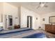Bright main bedroom featuring a ceiling fan, a walk in closet, and a wooden dresser at 2120 E Daley Ln, Phoenix, AZ 85024