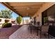 Outdoor patio with tile flooring, dining table, and covered seating area at 2120 E Daley Ln, Phoenix, AZ 85024