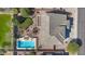 Aerial view of the property showcasing the roof, backyard, pool, patio, and lush landscaping at 2129 E Leo Pl, Chandler, AZ 85249