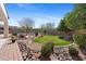 Beautiful backyard featuring a lawn, desert landscaping, a fire pit, and a view of the pool at 2129 E Leo Pl, Chandler, AZ 85249