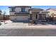 Beautiful two-story home featuring a three-car garage, covered porch, and desert landscaping at 2129 E Leo Pl, Chandler, AZ 85249