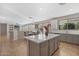 Spacious eat-in kitchen featuring an island with seating, grey cabinets, and stainless steel appliances at 2129 E Leo Pl, Chandler, AZ 85249