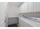 Well-organized laundry room with white cabinets, counter space, and modern washing machine and dryer at 2129 E Leo Pl, Chandler, AZ 85249