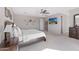 Bright main bedroom featuring a ceiling fan, a TV, and neutral-colored carpet flooring at 2129 E Leo Pl, Chandler, AZ 85249