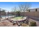 Backyard putting green and surrounding desert landscaping, complete with a pool view at 2129 E Leo Pl, Chandler, AZ 85249
