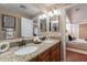Bathroom boasts double vanity with granite counters at 2318 E Flower St, Phoenix, AZ 85016