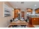 Inviting dining area showcasing a wooden table set for four, stylish decor, and wood flooring at 2318 E Flower St, Phoenix, AZ 85016