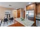 Well-appointed kitchen featuring wood cabinets, stainless steel appliances, and a dining area for casual meals at 2318 E Flower St, Phoenix, AZ 85016