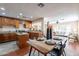 Bright, open kitchen and dining area with wood cabinets, an island, and a view into the living room at 2318 E Flower St, Phoenix, AZ 85016