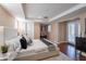 Well-lit bedroom with a large bed, stylish furnishings, and a door to the outdoor space at 2318 E Flower St, Phoenix, AZ 85016