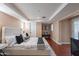 Cozy bedroom with a comfortable bed, stylish decor, plenty of natural light, and hardwood floors at 2318 E Flower St, Phoenix, AZ 85016