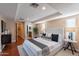 Spacious bedroom featuring a comfortable bed, hardwood floors, and access to an ensuite bathroom and closet at 2318 E Flower St, Phoenix, AZ 85016