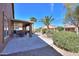 Spacious backyard with covered patio, fountain, desert landscaping, and mature trees at 2408 E Fiesta Dr, Casa Grande, AZ 85194