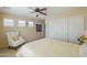 Bedroom features a chair, carpet, ceiling fan, and sunny windows with white plantation shutters at 2408 E Fiesta Dr, Casa Grande, AZ 85194