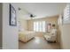 Cozy bedroom featuring neutral tones, plantation shutters, and a ceiling fan at 2408 E Fiesta Dr, Casa Grande, AZ 85194