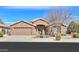 Charming single-story home featuring desert landscaping, a two-car garage, and a welcoming entrance at 2408 E Fiesta Dr, Casa Grande, AZ 85194