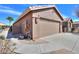 The two-car garage offers ample space for parking and storage with desert landscaping at 2408 E Fiesta Dr, Casa Grande, AZ 85194